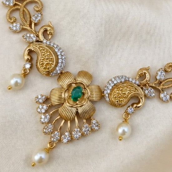 Gold-plated Peacock necklace jewelry floral
set featuring a necklace and matching earrings with green stone accents and white faux pearls