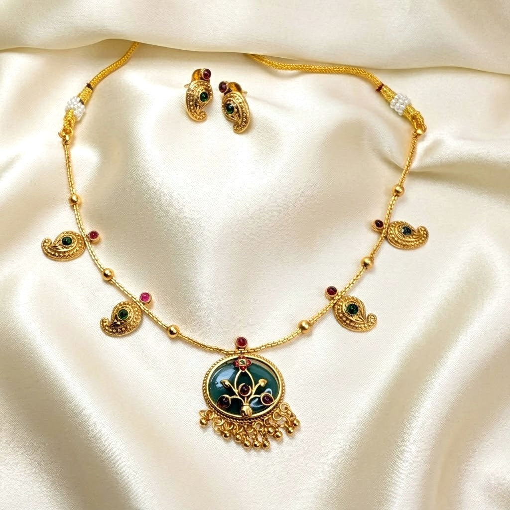 Gold necklace and earrings set on a Enamel Mango Pendant Chain Necklace